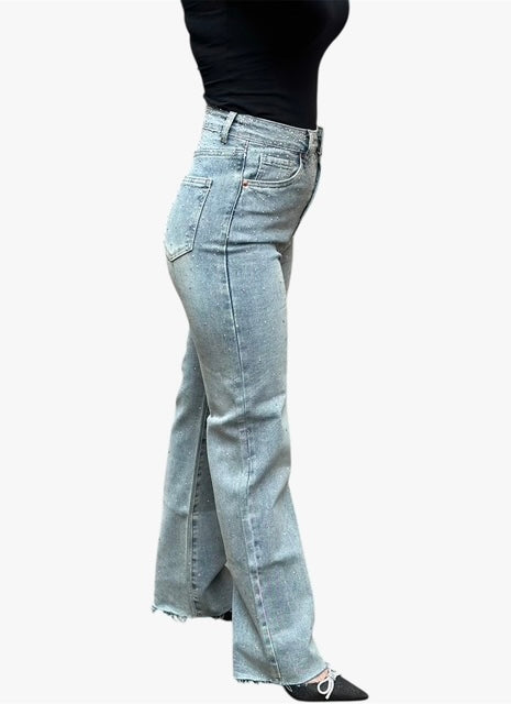 Light blue jeans with a front slit worn by a person on a white background
